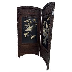Meiji period (1868–1912), Shibayama lacquer carved hardwood two-fold screen inlaid with mother-of-pearl, bone, and ivory, decorated on one side in high relief and inlaid in a  Shibayama manner with oriental storks flying below flowering branches,  the reverse lacquer panels depicting flowering cherry trees. This item has been registered for sale under section 10 of the APHA Ivory Act.