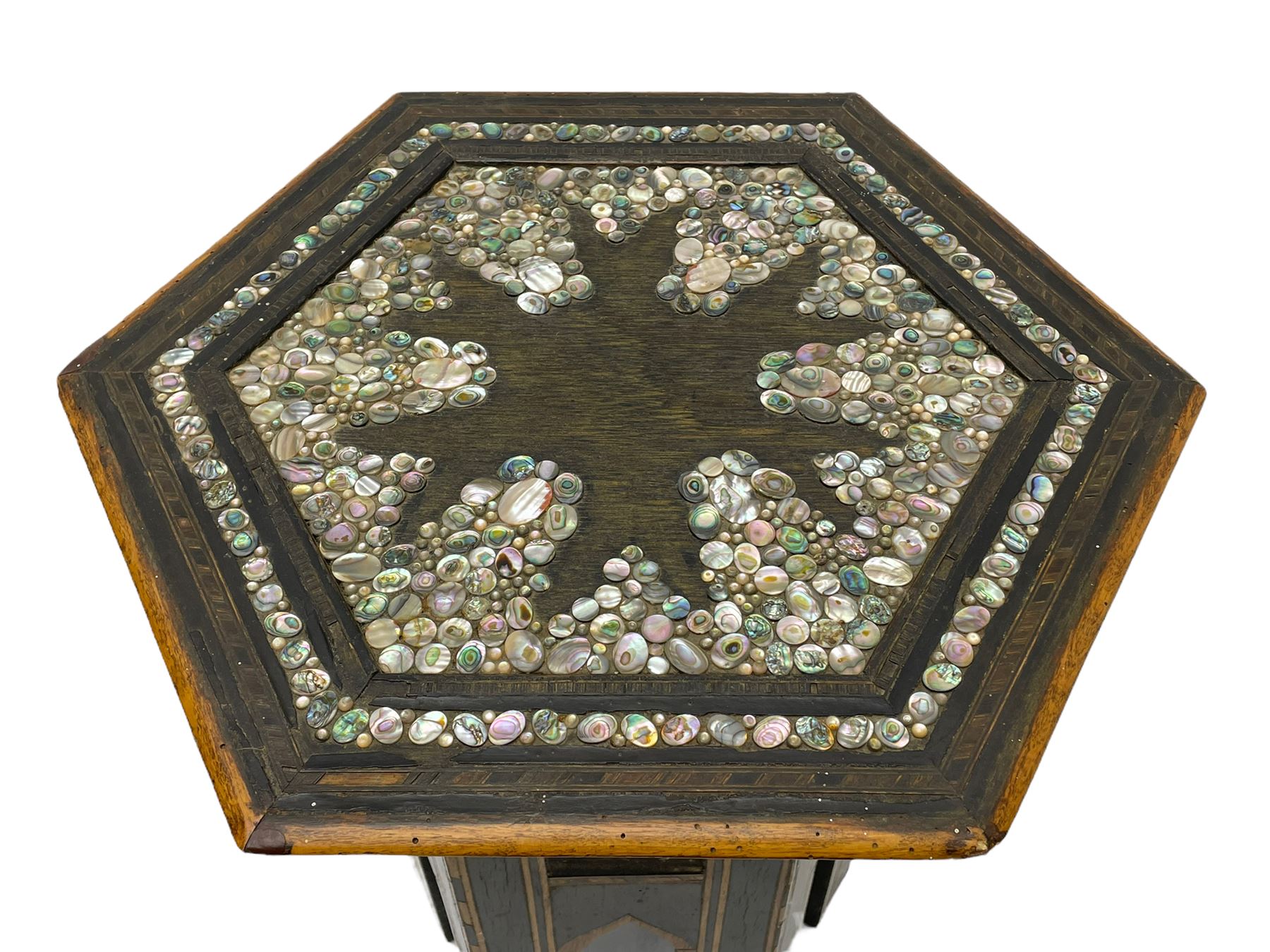 Early 20th century Anglo-Indian hexagonal table, the top decorated with mother of pearl beads and chequered banding, the base with fretwork pointed arches and inlays