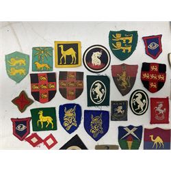 Approximately one-hundred printed and embroidered cloth badges including Royal Tank Regiment, Royal Armoured Corps, 219th Independent Infantry Brigade, Cyrenaica, Cyprus, Singapore and other districts, Gibraltar Garrison, East Anglian Brigade, 20th Armoured Brigade and various armoured divisions etc