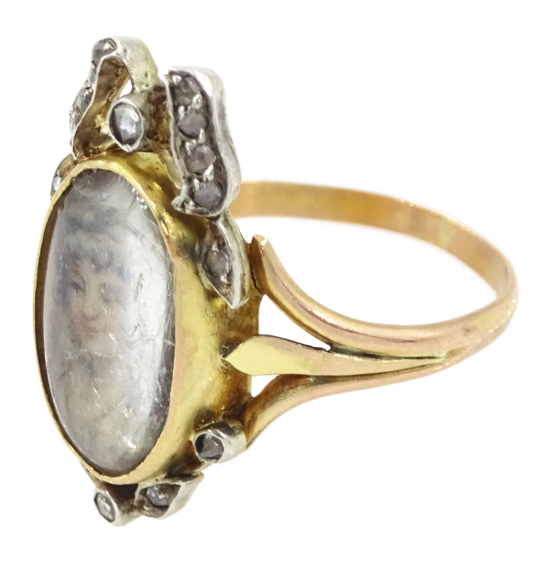 19th century gold and silver diamond portrait ring, set with an oval miniature of a woman on ivory, under a glazed panel, with rose cut diamond bow and floral sprigs below, to trifuricated shoulders. This lot has been registered for sale under Section 10 of the APHA Ivory Act