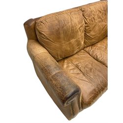 Two-seat club sofa, rolled arms upholstered in tan leather with stud work bands, on turned feet 