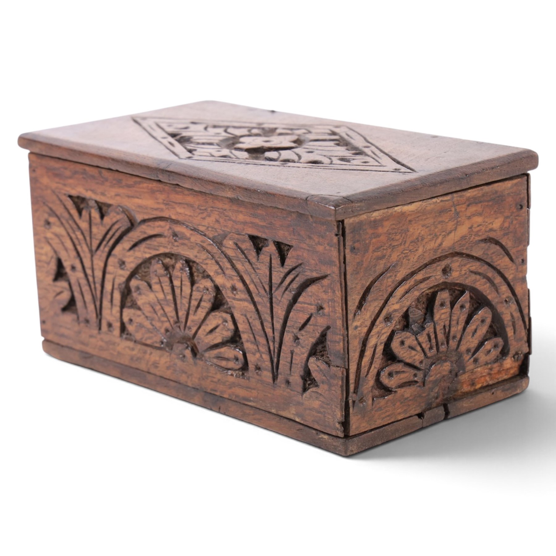 Carved oak box, the hinged lid with a carved diamond motif, the sides and front carved with stylised flowers, H12cm, L24cm