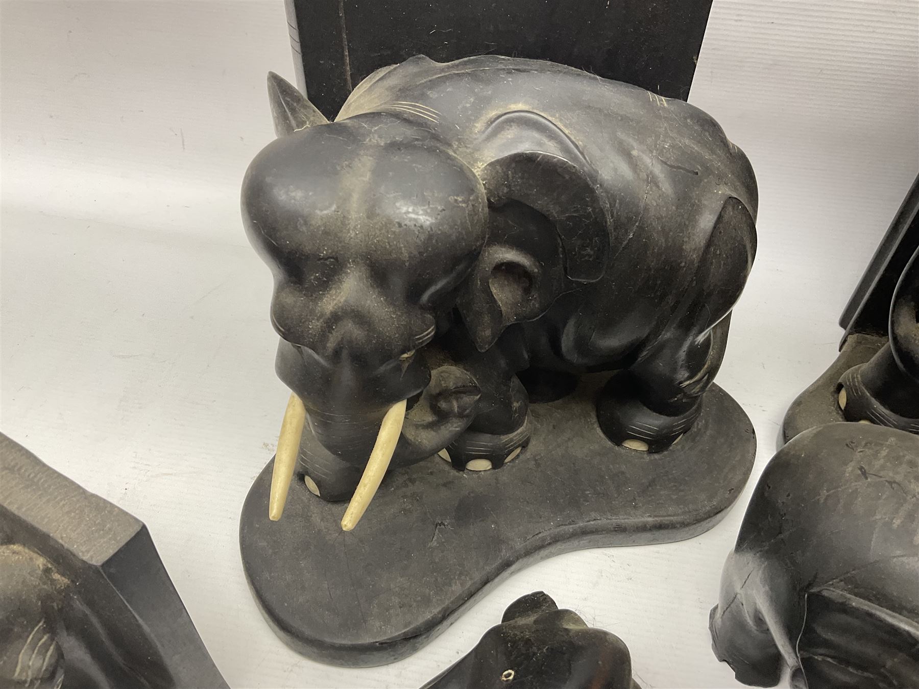 Three pairs of carved wooden elephant bookends, and a similar carved wooden elephant figure, tallest H24cm
