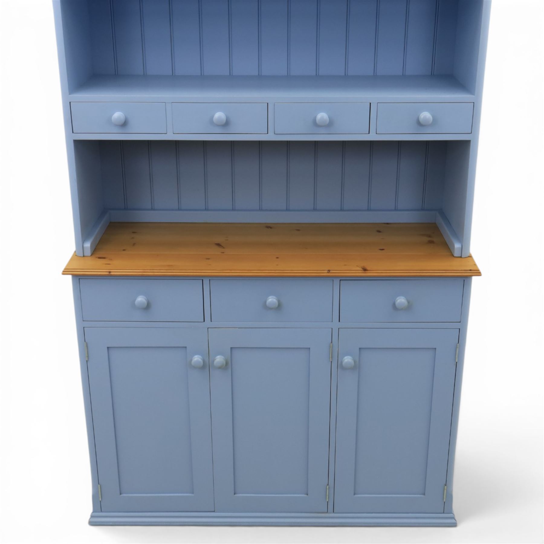 Pine blue painted dresser, upper section with tongue and grove back, two shelves with three short drawers, above a base with soft close short drawers, and three cupboard doors, raised on a moulded plinth base