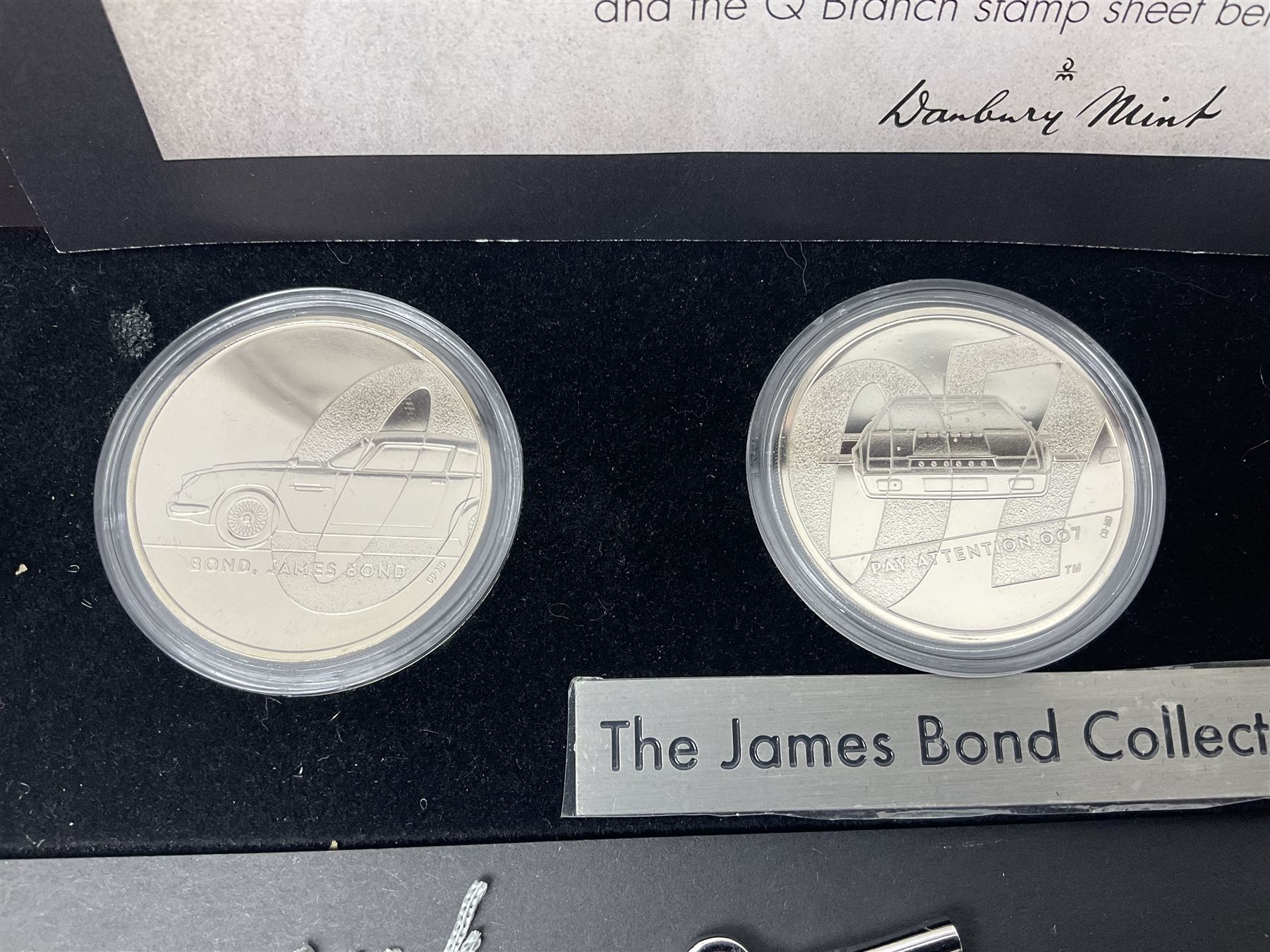 Danbury Mint 'The Ultimate James Bond Collection' comprising stamps and coins housed in a display case, 'Concorde Queen of the Skies' sculpture, stamps, medallion display and 2020 'Centenary of the Unknown Warrior' five pound coin cover in Harrington and Byrne folder