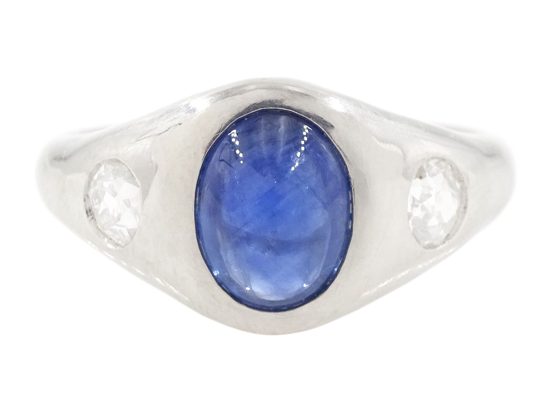 Platinum sapphire and diamond three stone ring, single cabochon sapphire of 1.65 carat, with a rubover set old cut diamond set either side, stamped 850 Plat, total diamond weight 0.42 carat