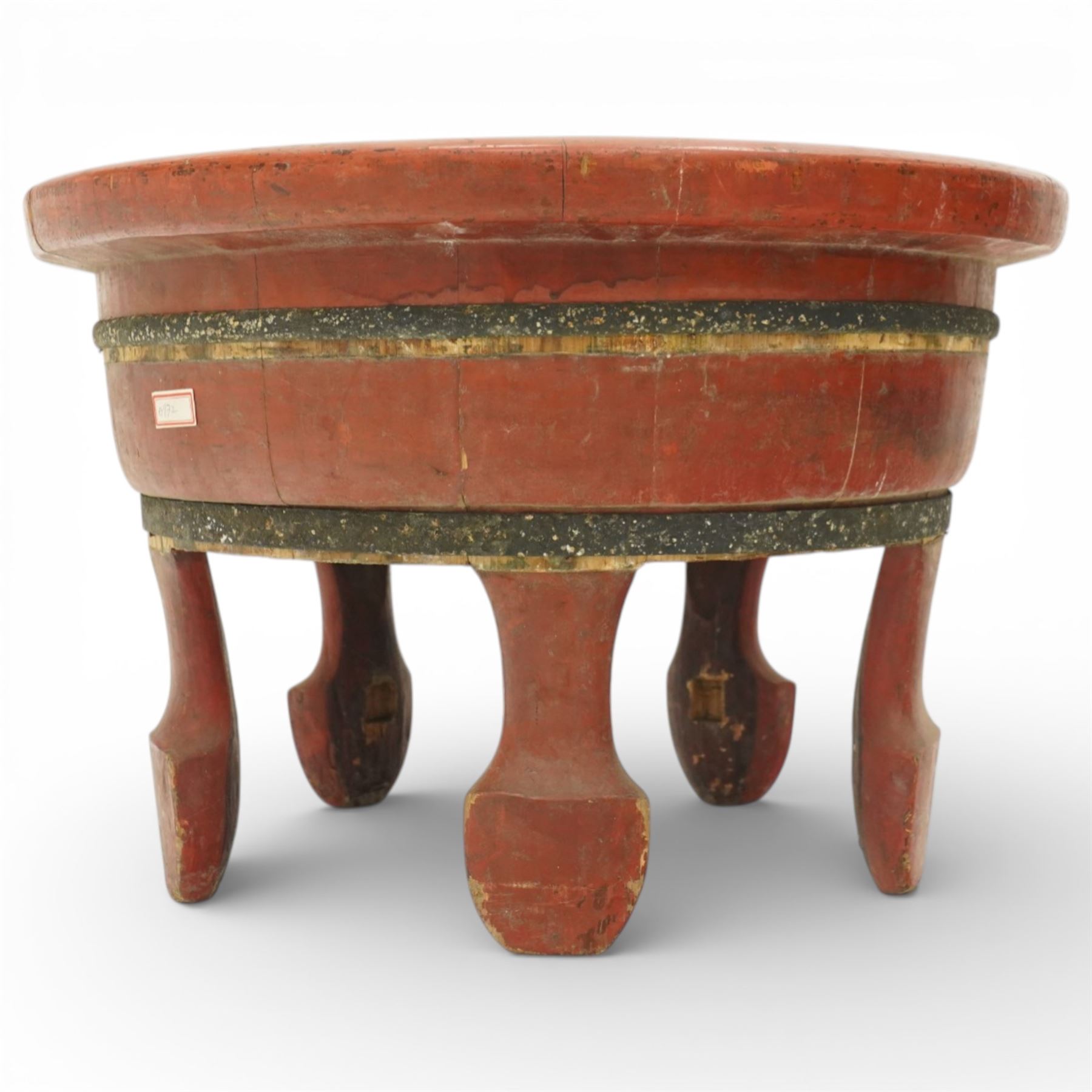 Chinese red painted wooden wash bowl, of circular form with a thickened rim above a tapering body with painted bands, raised on five short supports