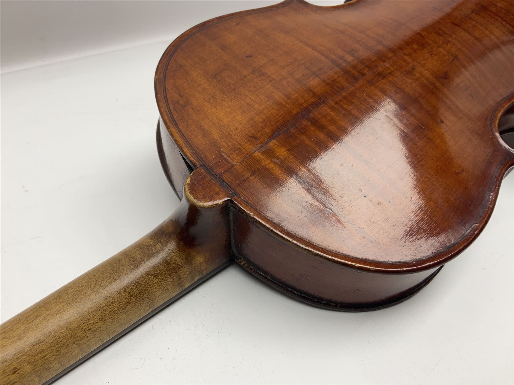 German violin c1890 with 36cm two-piece maple back and ribs and spruce top; bears label 'Antonius Stradivarius Cremona Faciebat Anno 1729' L59.5cm overall; in ebonised wooden 'coffin' case; and two German violins c1890 for completion - one bearing a Stradivarius label, the other a Ruggeri label; both in carrying cases (3)