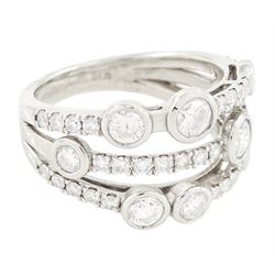 Platinum diamond three row split design ring, nine bezel set round brilliant cut diamonds, spaced by smaller round brilliant cut diamonds, hallmarked, total diamond weight 1.70 carat 
