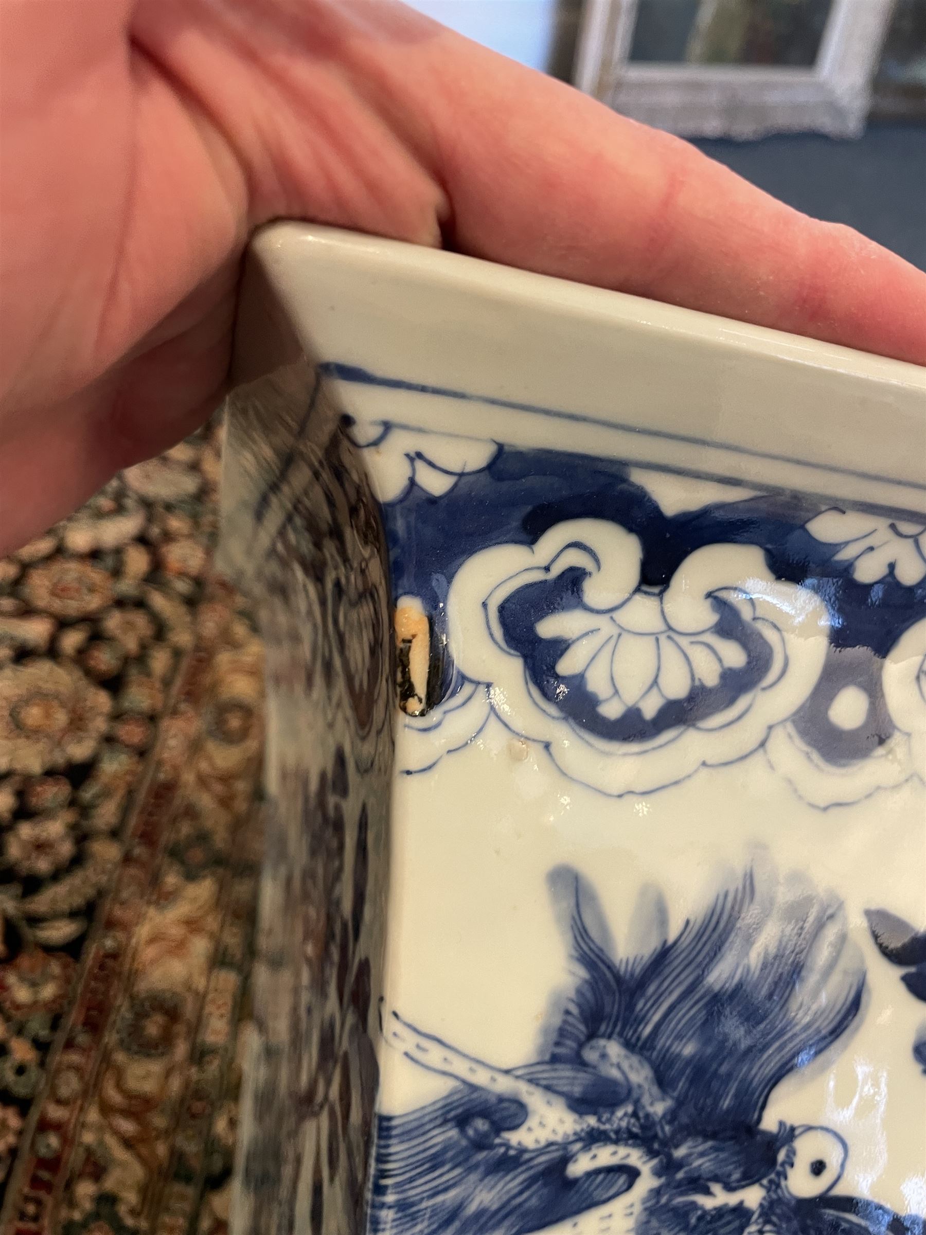 Chinese blue and white planter and stand, each of square slightly tapering and flared form, the planter decorated with two dragons and blossoming peonies, between stylised borders, the stand decorated with flower heads and vines, planter H30cm W29cm, stand H7cm D28.5cm