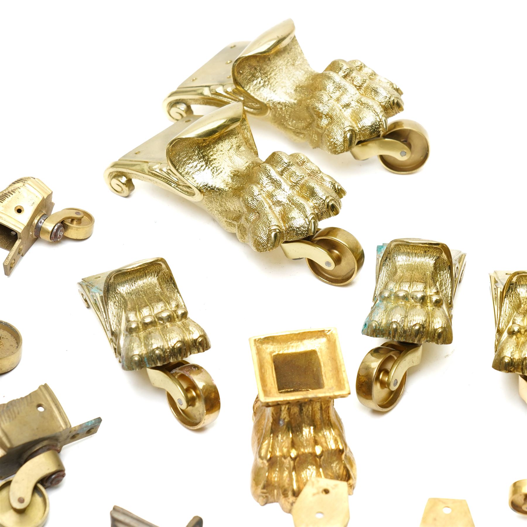 Set of four period design lacquered brass paw furniture castors by Beardmore, London, set of four matching smaller castors and a quantity of various brass castors   
Provenance: property of a Nobleman