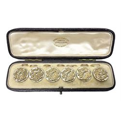 Set of six early 20th century gilt buttons, with stylised foliate decoration, in silk leather and velvet case stamped 'Streeter & Co, New Bond Street, London' 