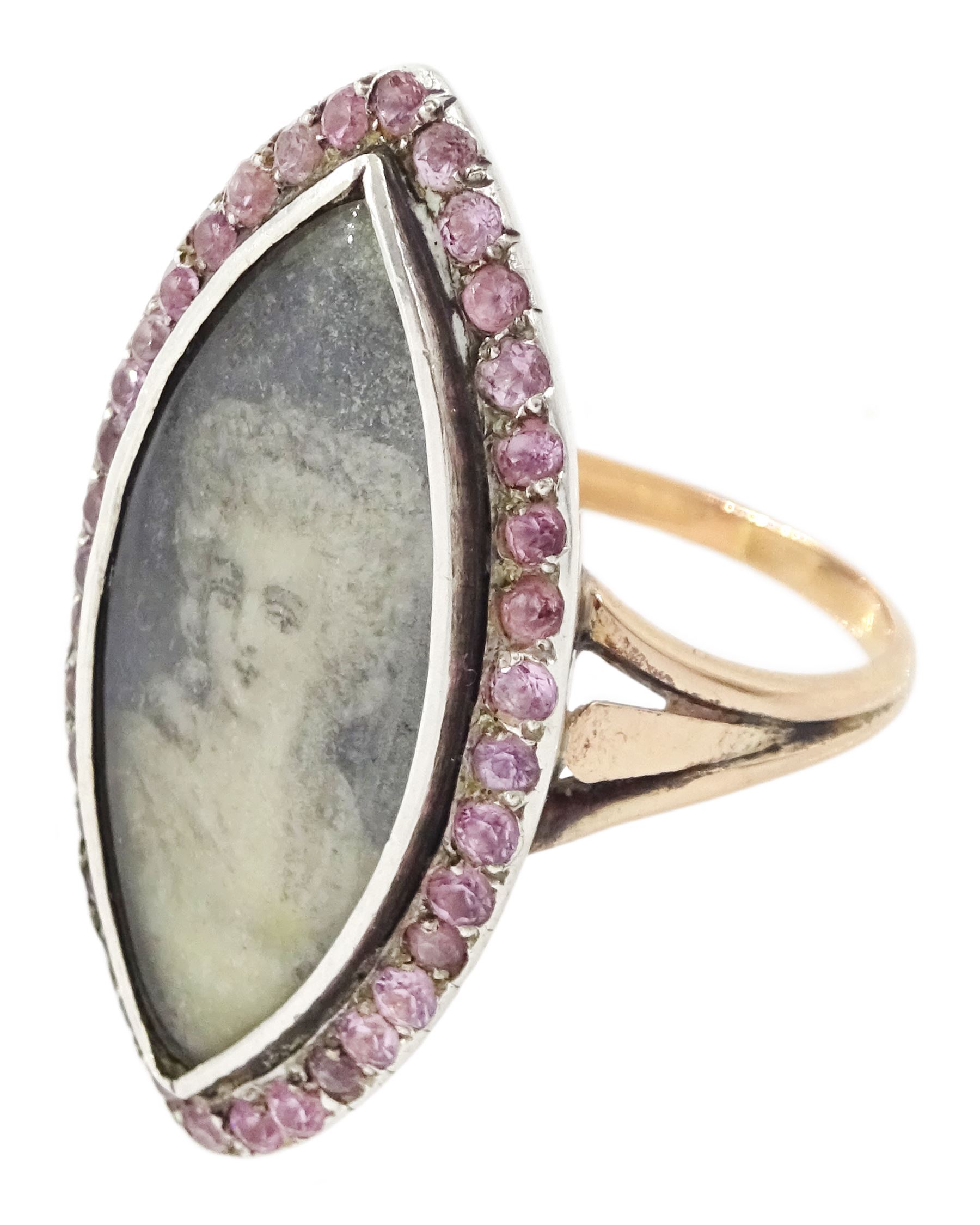 18th / 19th century gold and silver paste stone set portrait ring, the navette bezel set with a miniature of a woman on ivory, under a glazed panel, within a pink paste border and trifurcated shoulders. This lot has been registered for sale under Section 10 of the APHA Ivory Act