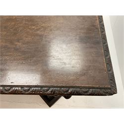 Large 19th century carved oak library table, the rectangular top with lunette carved edge over cartouche panelled and carved  scroll frieze, the central tapering rectangular support relief carved with masks and garlands, on four carved seated lion supports at each corner, on flat angular stretcher with recessed castors stamped ‘Bartholomew & Fletcher, London’