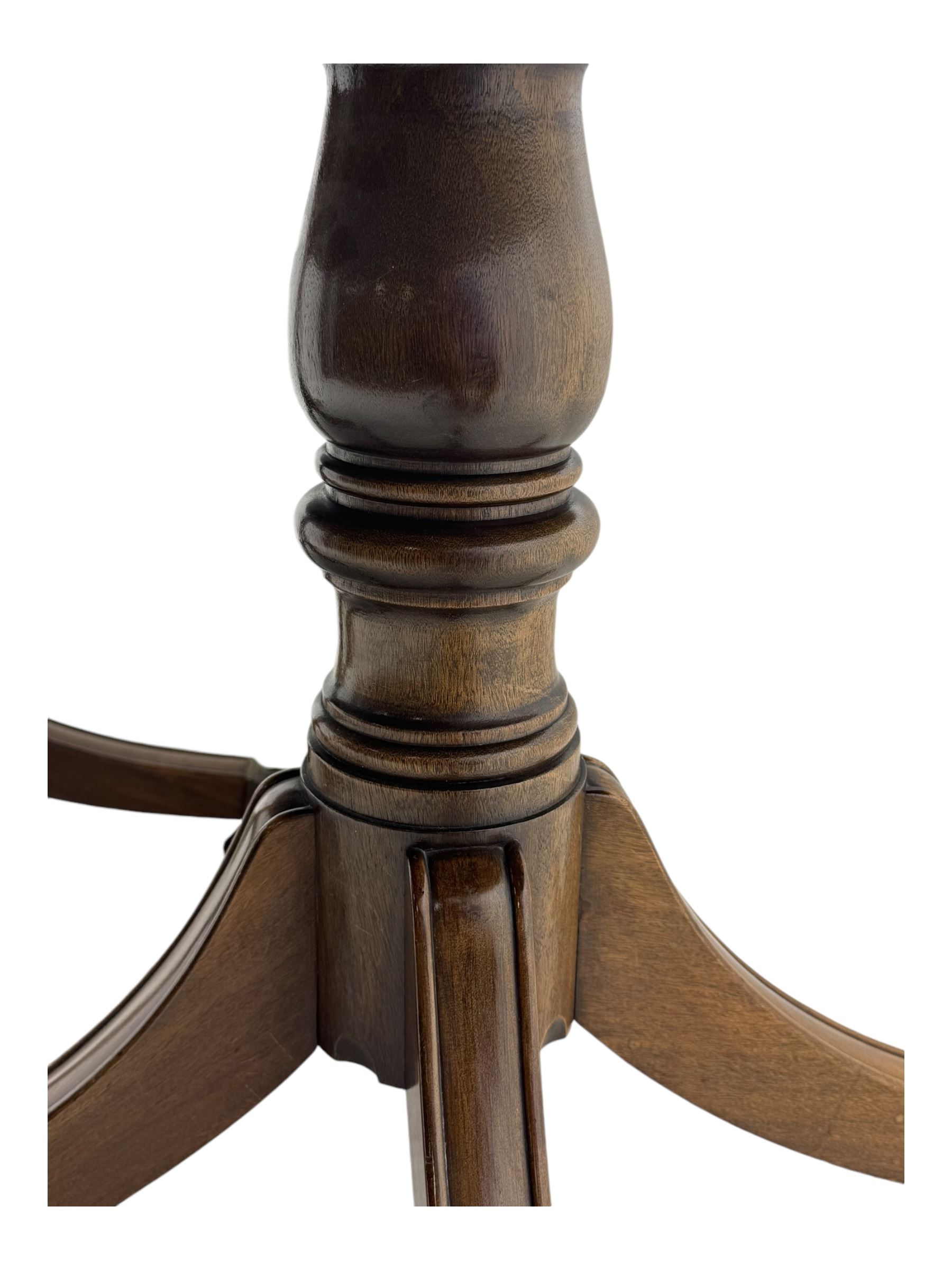 Georgian design mahogany twin pedestal dining table, oval top with reeded edge, single additional leaf, on turned pedestal with four out splayed supports, cast brass hairy paw castors 