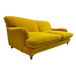 Loaf - large two seat 'Jonesy' sofa, upholstered in mustard velvet fabric with sprung back and loose seat cushions, raised on pale oak turned supports