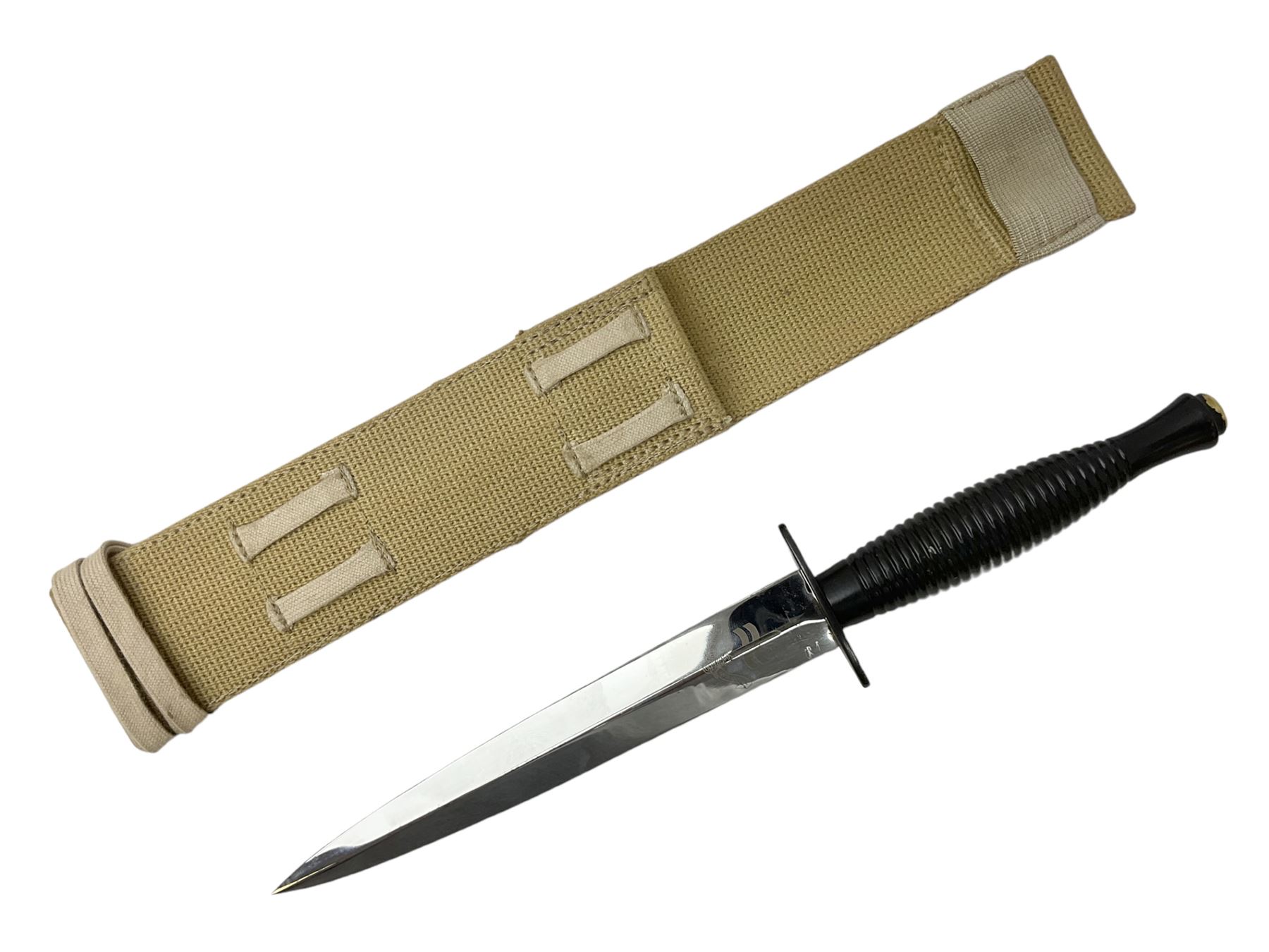 Gulf War period commando knife with 17cm double-edged steel blade etched with the crest and motto 'By Strength and Guile', blackened cross-piece and grip; in webbing scabbard L31cm overall