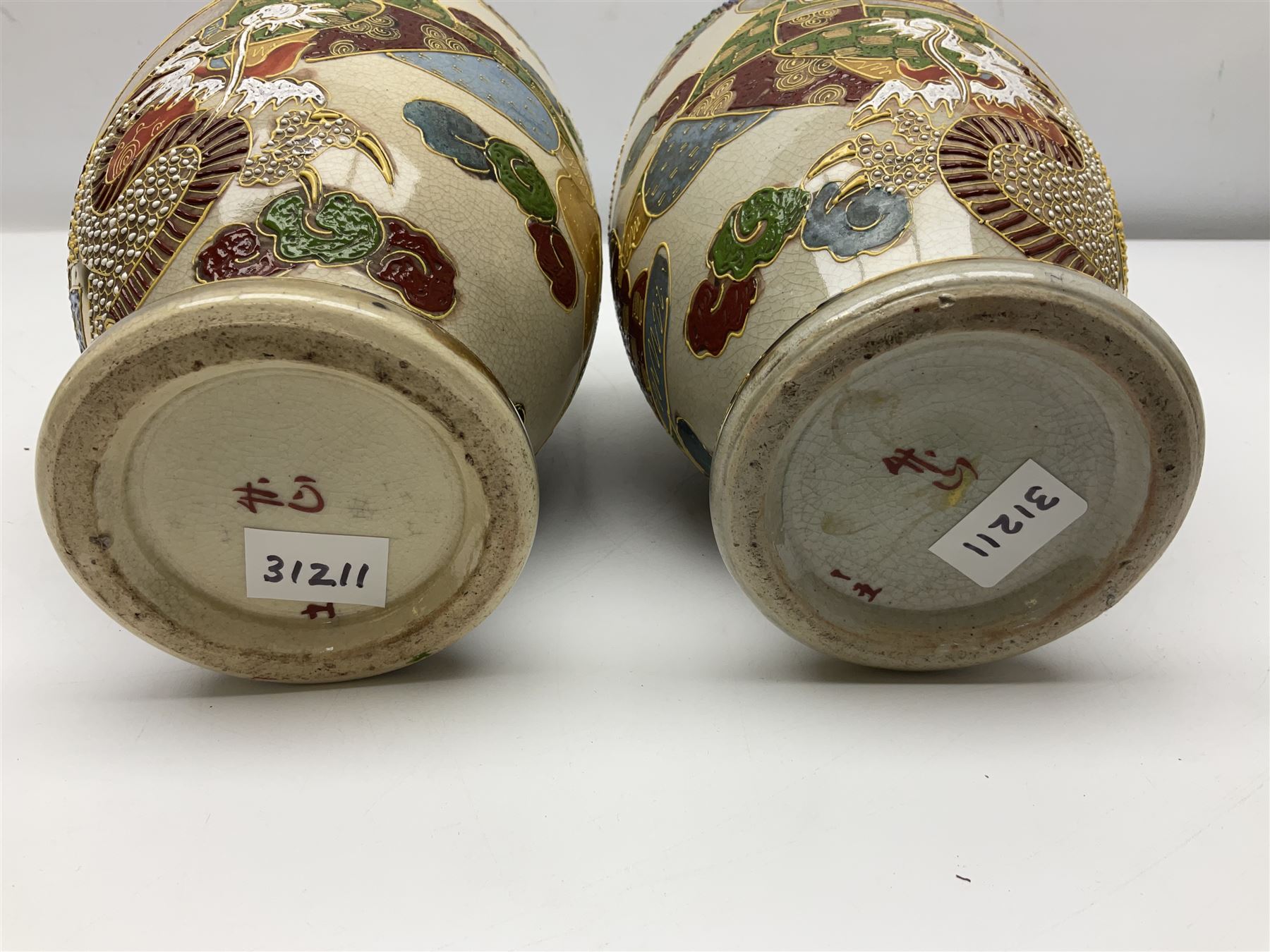 Pair of early 20th century Japanese Satsuma vases, decorated with immortals, with painted mark to base, H26cm