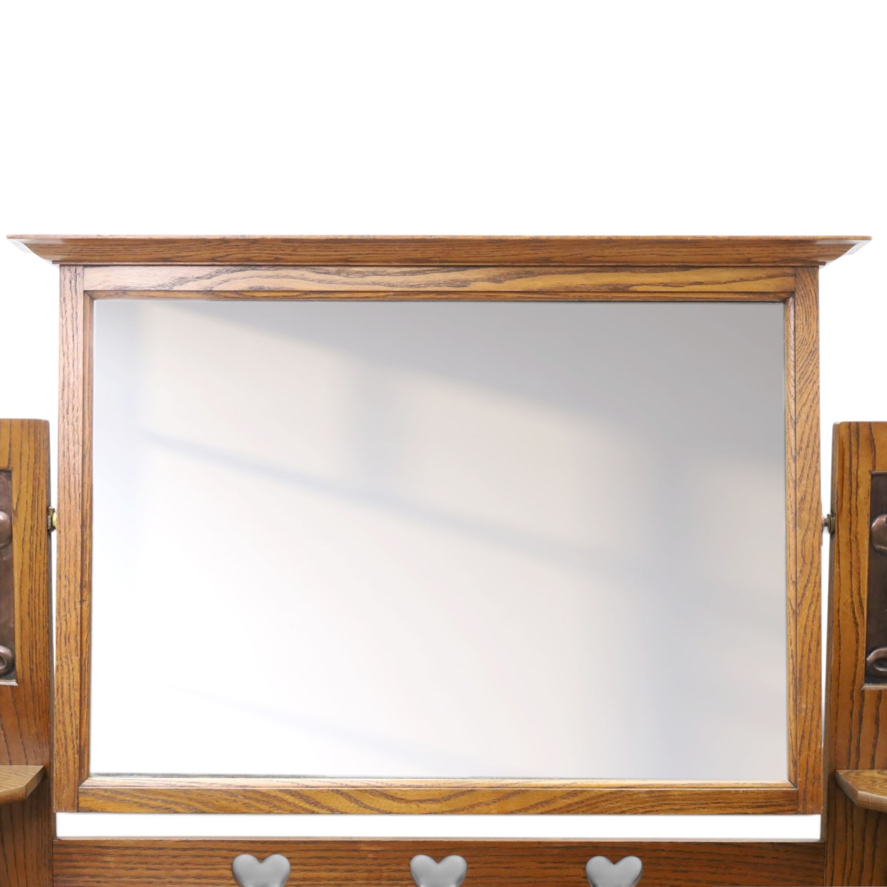Shapland & Petter - oak mirrored dressing chest, tilted mirror flanked by tulip carved supports, shaped shelves with heart cut outs, above two short over one long drawers, with brass handles and stamped S & P on the locks, raised on shaped supports