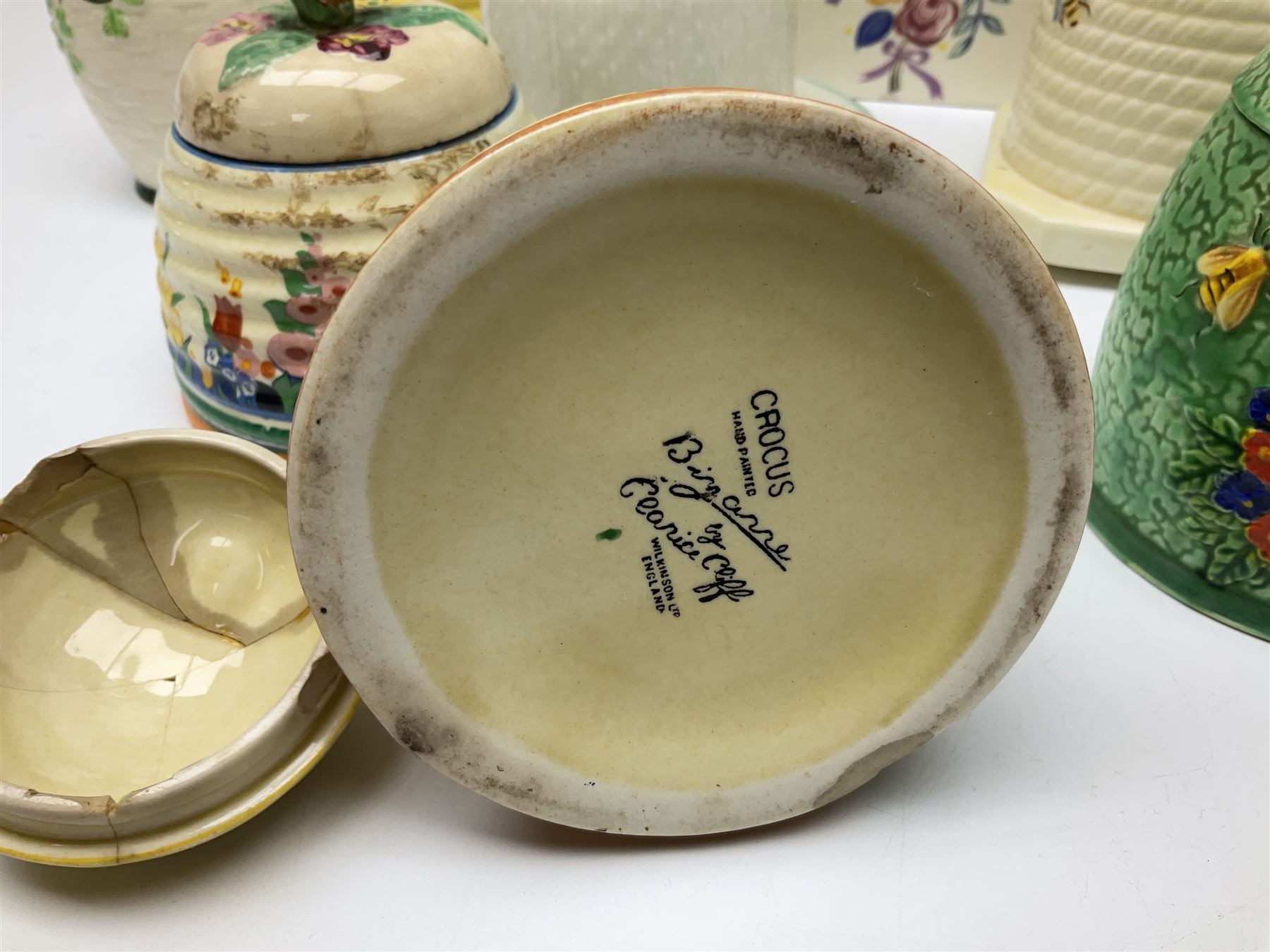 Clarice Cliff for Wilkinson Ltd Crocus Bizarre beehive honeypot painted in the Crocus pattern, together with two beehive Beswick honey pots, Poole square honey pot etc (14)