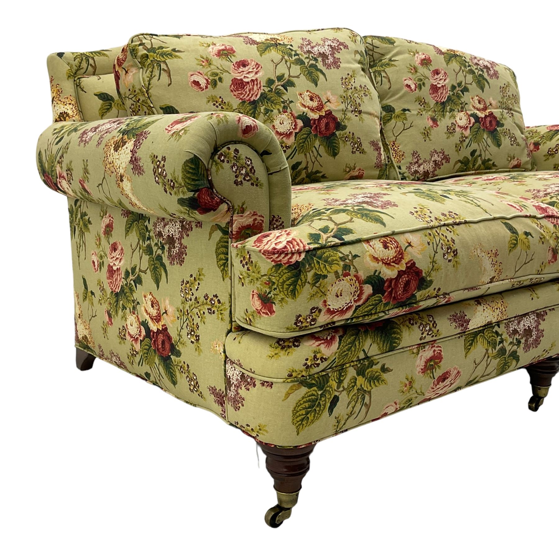 Hancock & Moore - two-seat sofa, upholstered in pale green ground fabric decorated with floral pattern, traditional shape with rolled arms and arched back, on turned front feet with brass cups and castors 