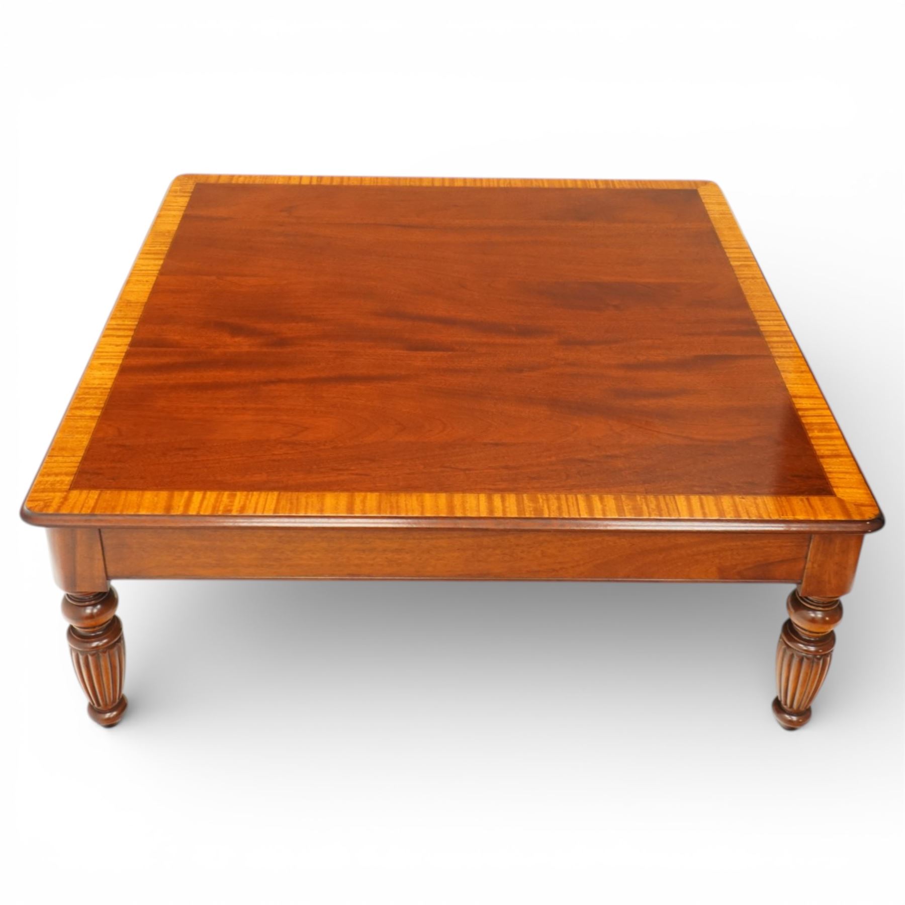 Georgian design mahogany coffee table, square top with satinwood crossbanded border above plain frieze, raised on turned and fluted supports