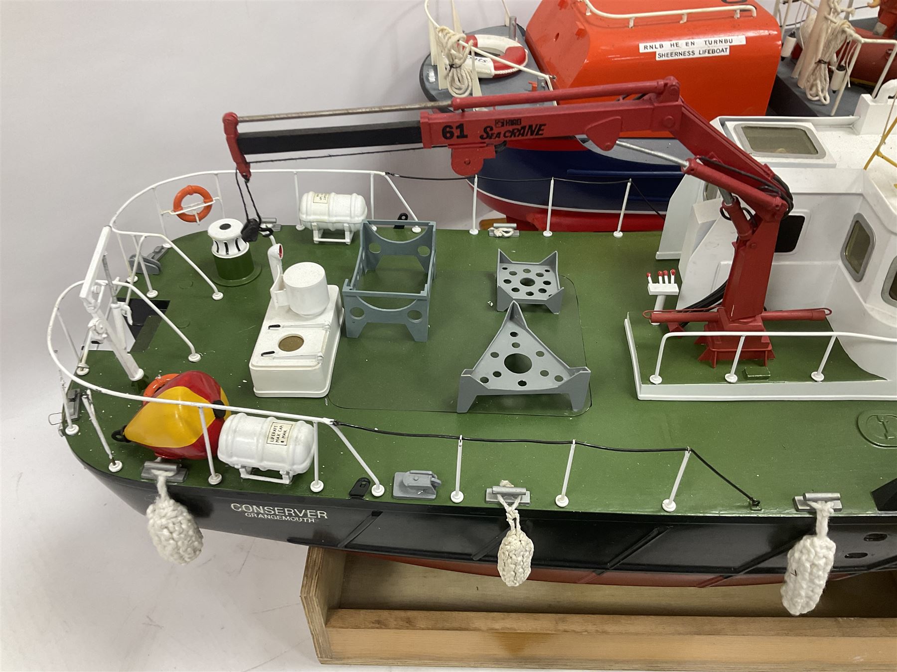 Two remote controlled kit-built plastic model boats - RNLB Sheerness Lifeboat Helen Turnbull L92cm and 'Conserver' Grangemouth L76cm; each on wooden stand; together with three remote control units