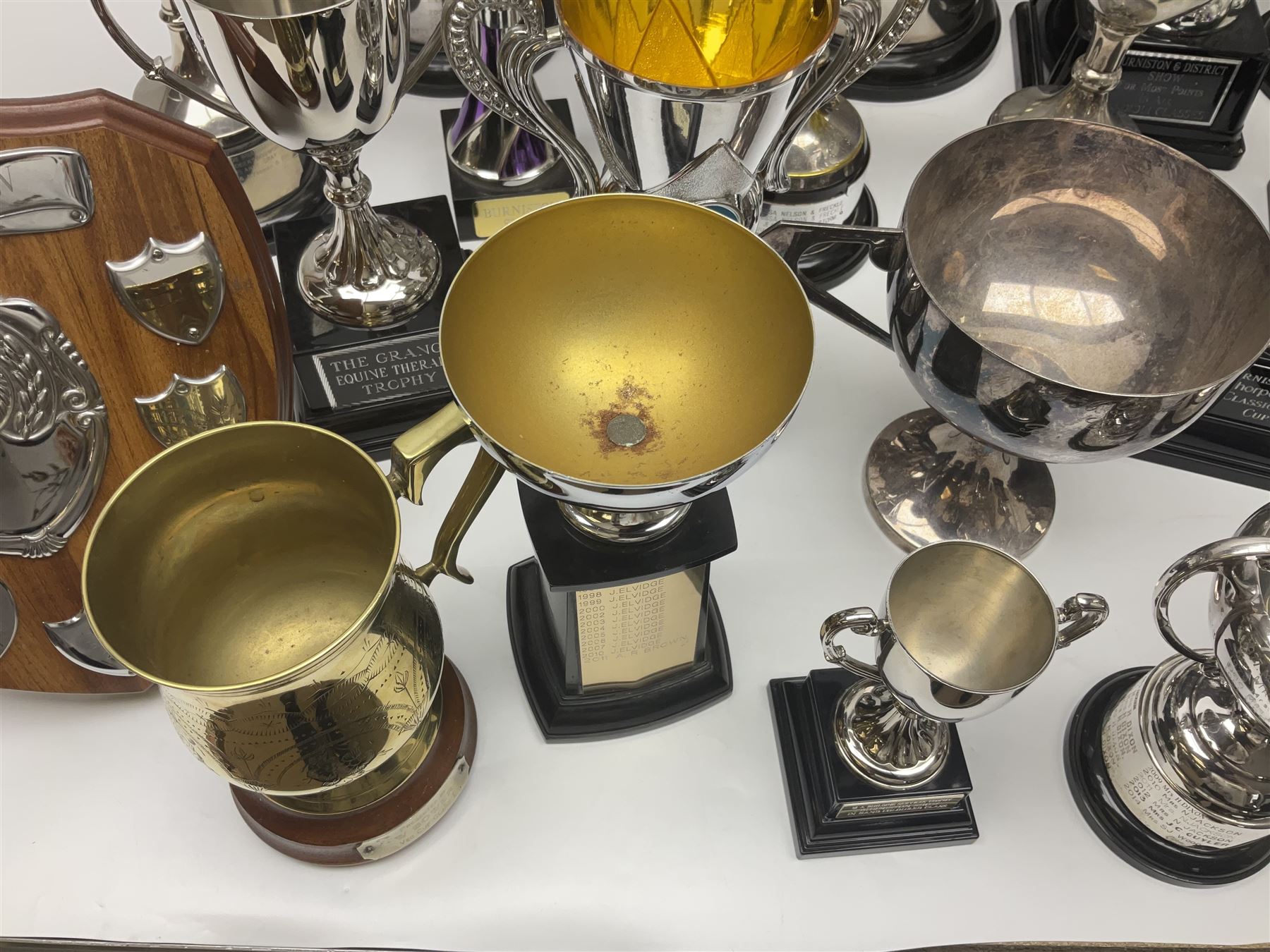 Collection of silver plated and metal trophy cups and winners plaques, all relating to the Burniston and District Show, most engraved with competitions and winner's names, in three boxes 