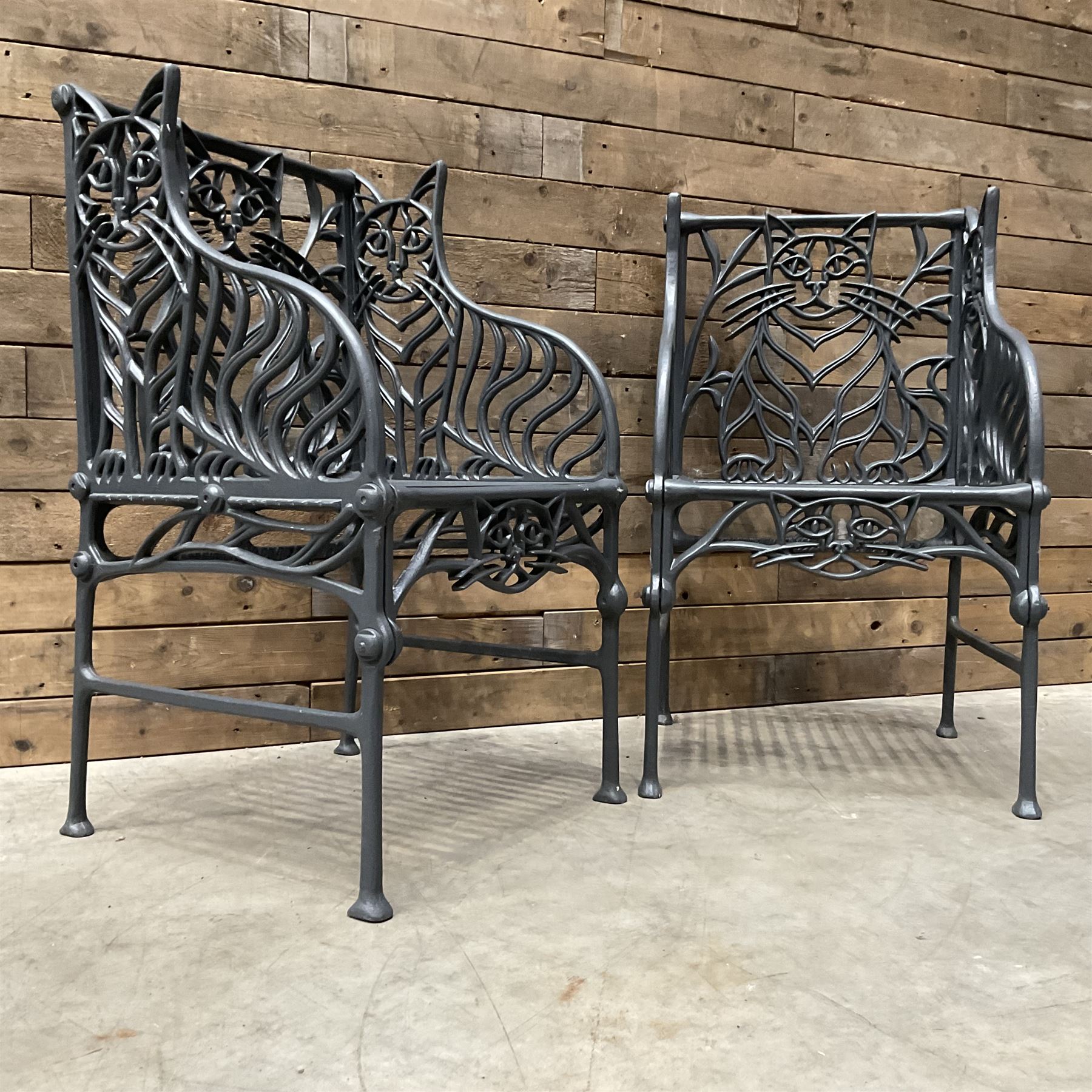 Richard Bawden (1936-2024): Pair of Cat design painted cast iron garden armchairs