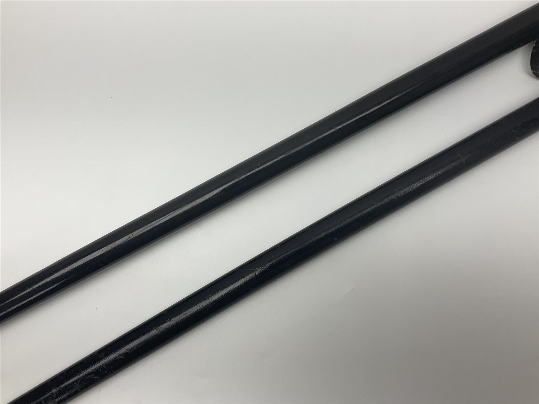 Two ebonised walking sticks, one with 'Leeds City Police' embossed top, tallest H92cm