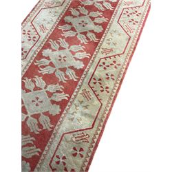 Turkish design rug, red ground and decorated with geometric pattern (192cm x 141cm), and a runner (200cm x 81cm)