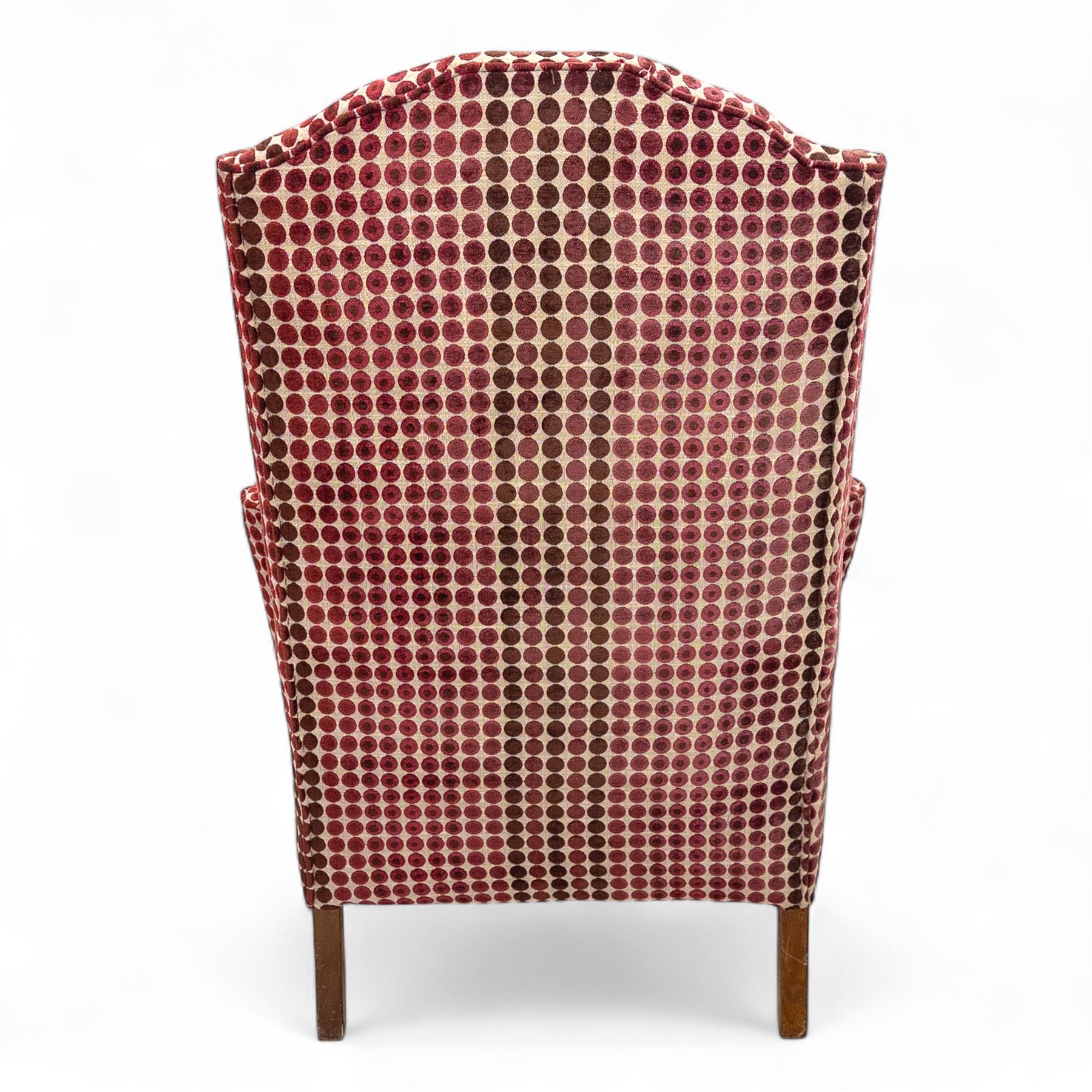 Late 20th century Georgian style wingback armchair with matching footstool, upholstered in red and cream geometric fabric, raised on cabriole front legs