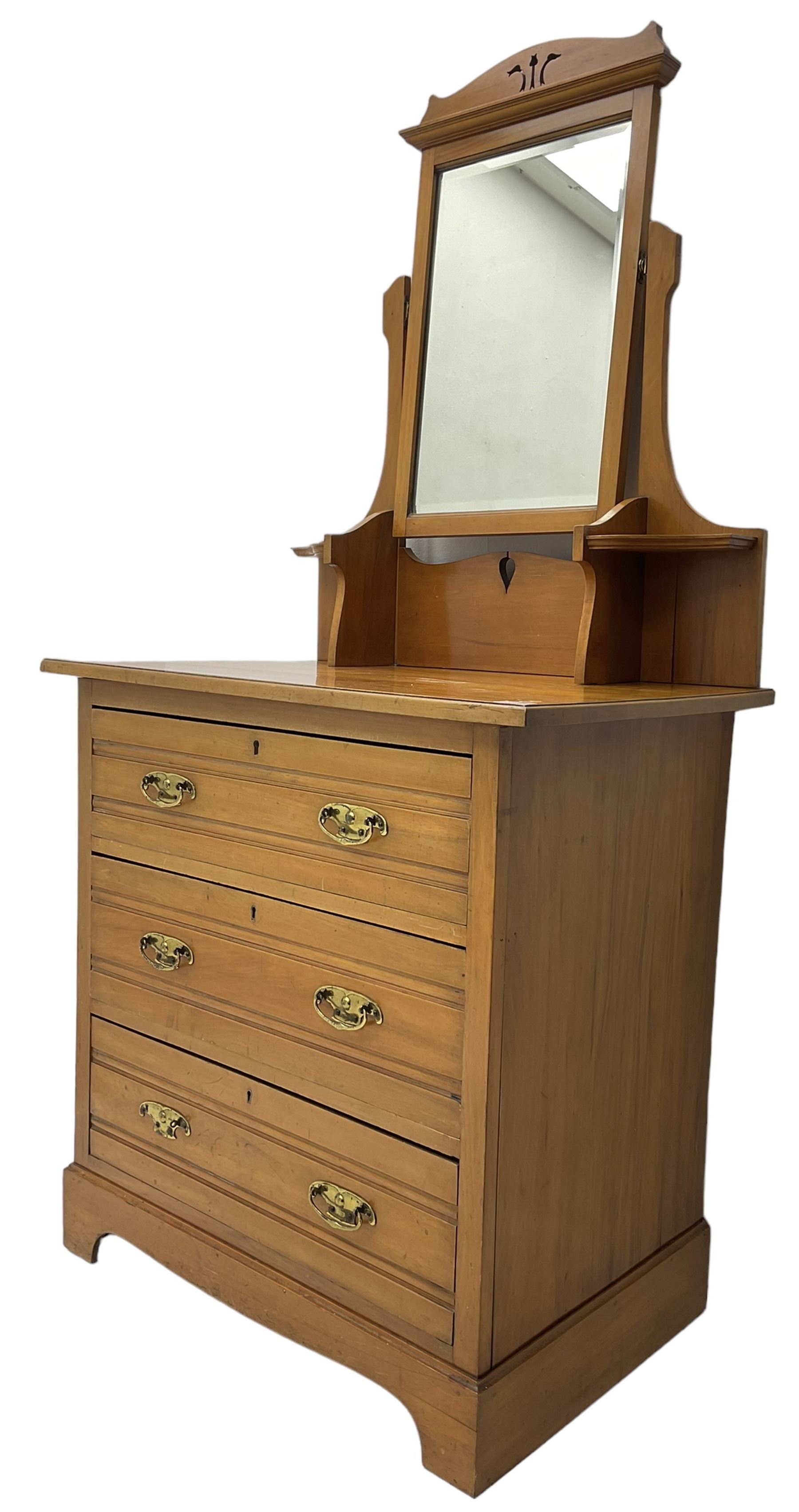 Edwardian satin walnut dressing chest, raised bevelled mirror back, the base fitted with three drawers