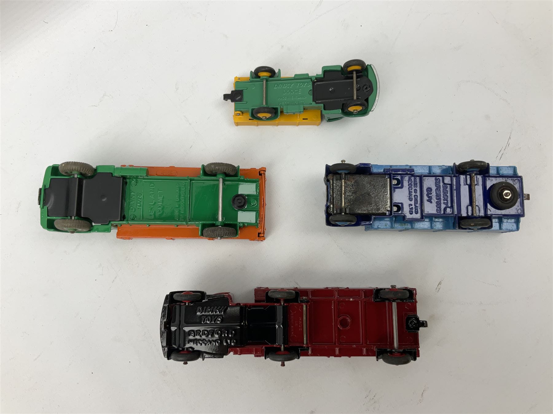 Dinky - seven unboxed and playworn/repainted die-cast commercial vehicles comprising Bedford Articulated lorry, Leyland Comet, Big Bedford, Ford 800 tipper truck, Guy flatbed and planked flatbed lorries and Dodge tipper truck (7)
