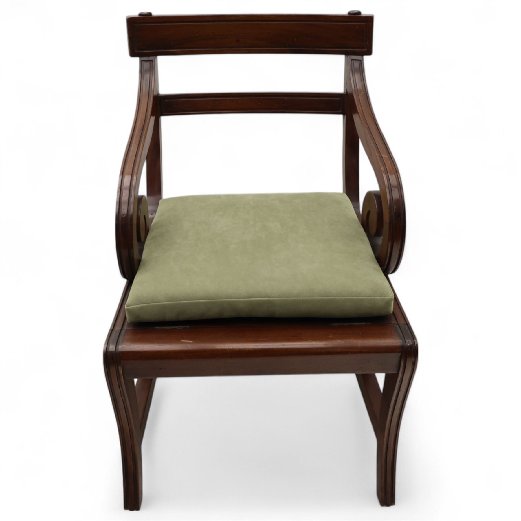 In the manner of Morgan & Sanders - early 20th century Regency design mahogany metaphoric library chair and steps, rectangular panelled top-rail with applied roundels with scrolling arms and upholstered seat and cushion, hinged and folding design transforming into four carpeted steps

Reference: The present lot is based on a design for a metamorphic library chair published by Morgan & Saunders circa 1810, P.Agius, Ackermann's Regency Furniture & Interiors, plate 29, page 60