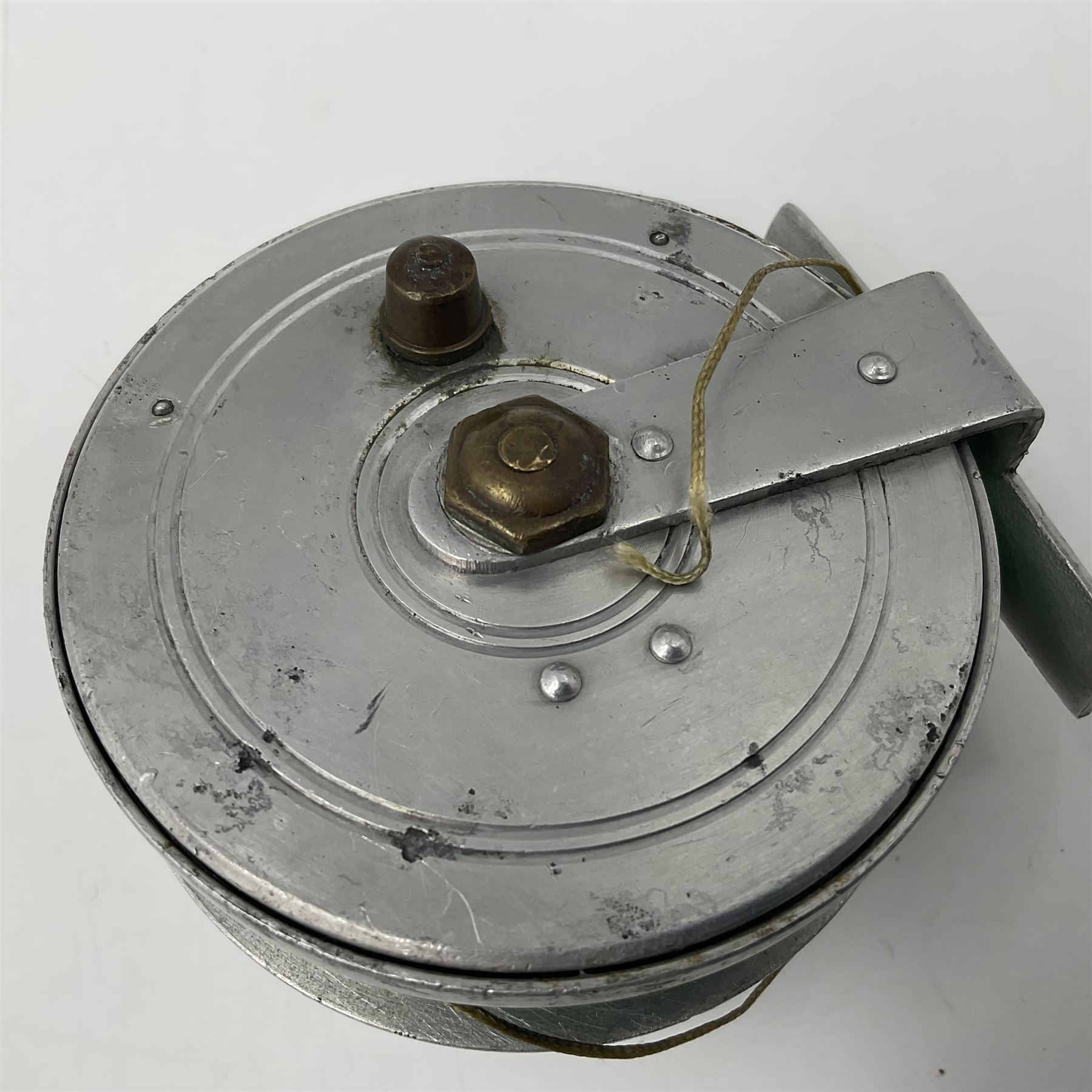 TO RTV Three fishing reels, including American Pflueger progress bulldog size 60 brass and chrome skeleton fly reel, with wooden handle; Maginot 106 fly reel and an alloy reel (3)