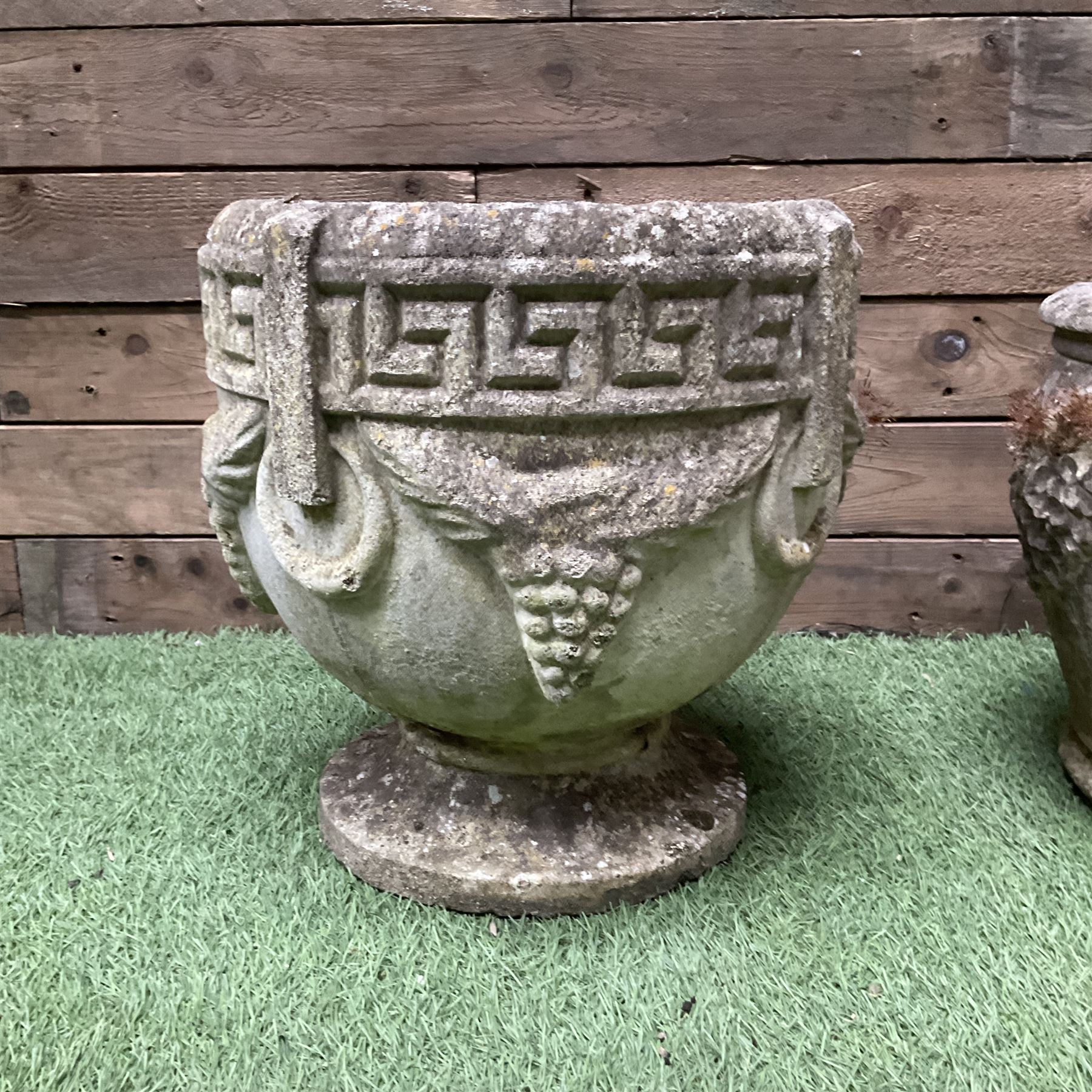 Pair of cast stone planters decorated in grapes