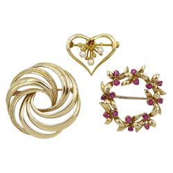 Gold ruby leaf design wreath brooch, gold pearl and pink stone heart brooch and a gold swirl brooch, all hallmarked 9ct