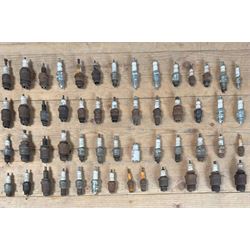 Group of collectable spark plugs, mostly used, mainly by Champion, and some earlier exampl...
