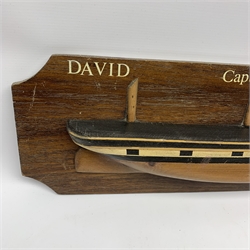 Elm hull only half-block model of the three-masted sailing ship 'David' from Hull under the command of Capt. Amos with black and white painted gunports, on mahogany finish backboard dated 1877 L68cm