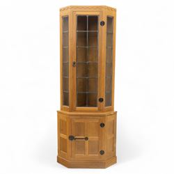 Mouseman - oak standing corner cabinet with leaded glass top above a panelled base, iron s...