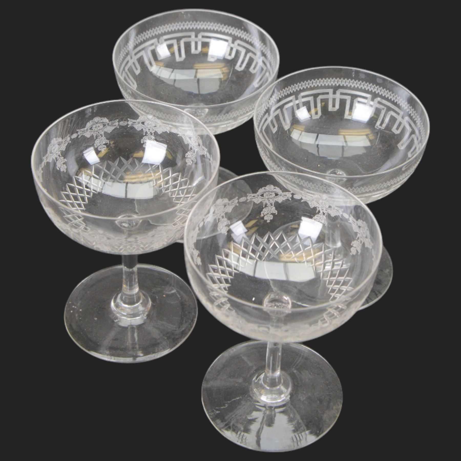 Six cut glass goblets, each with etched and cut floral decoration, together with eight similar bowls, a pair of Waterford Crystal glasses, eight champagne coupes etched with Greek Key border and four etched with floral border