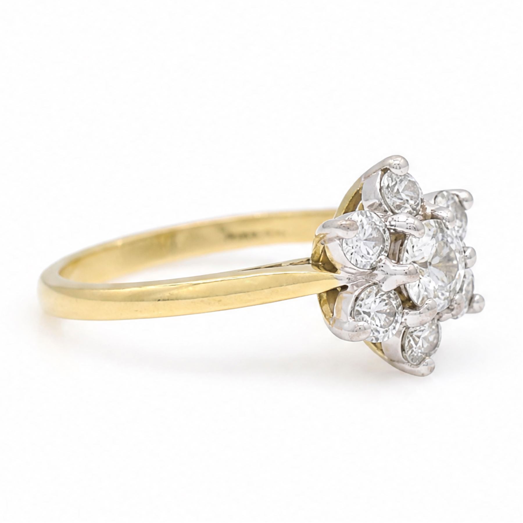 18ct gold diamond flower head cluster ring, principal round cut diamond of approx 0.55 carat, surrounded by six round brilliant cut diamonds, hallmarked, total diamond weight 1.15 carat