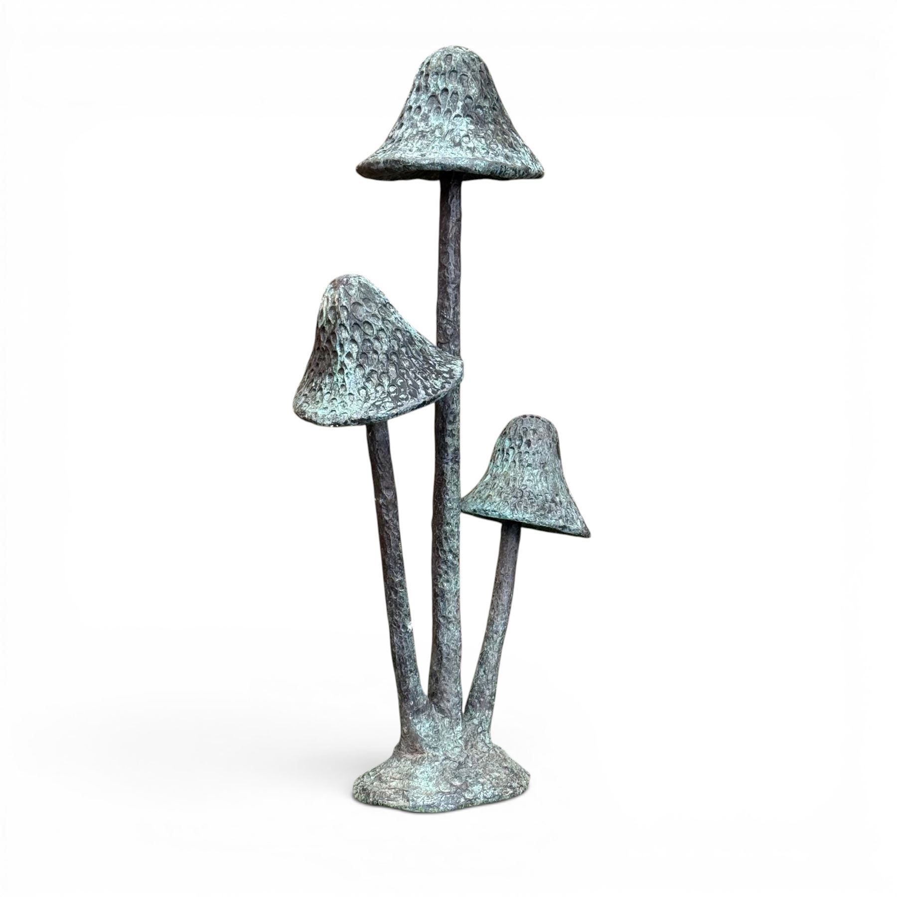 Bronze garden ornament in the form of three mushroom stalks, on naturalistic base