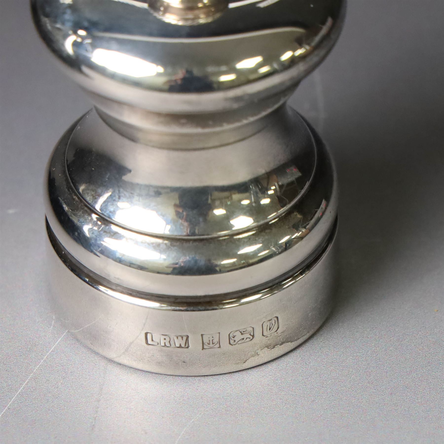 Silver mounted glass decanter, boxed with wooden plinth, together with a silver pepper grinder and a silver mounted Carrs desk clock, all hallmarked