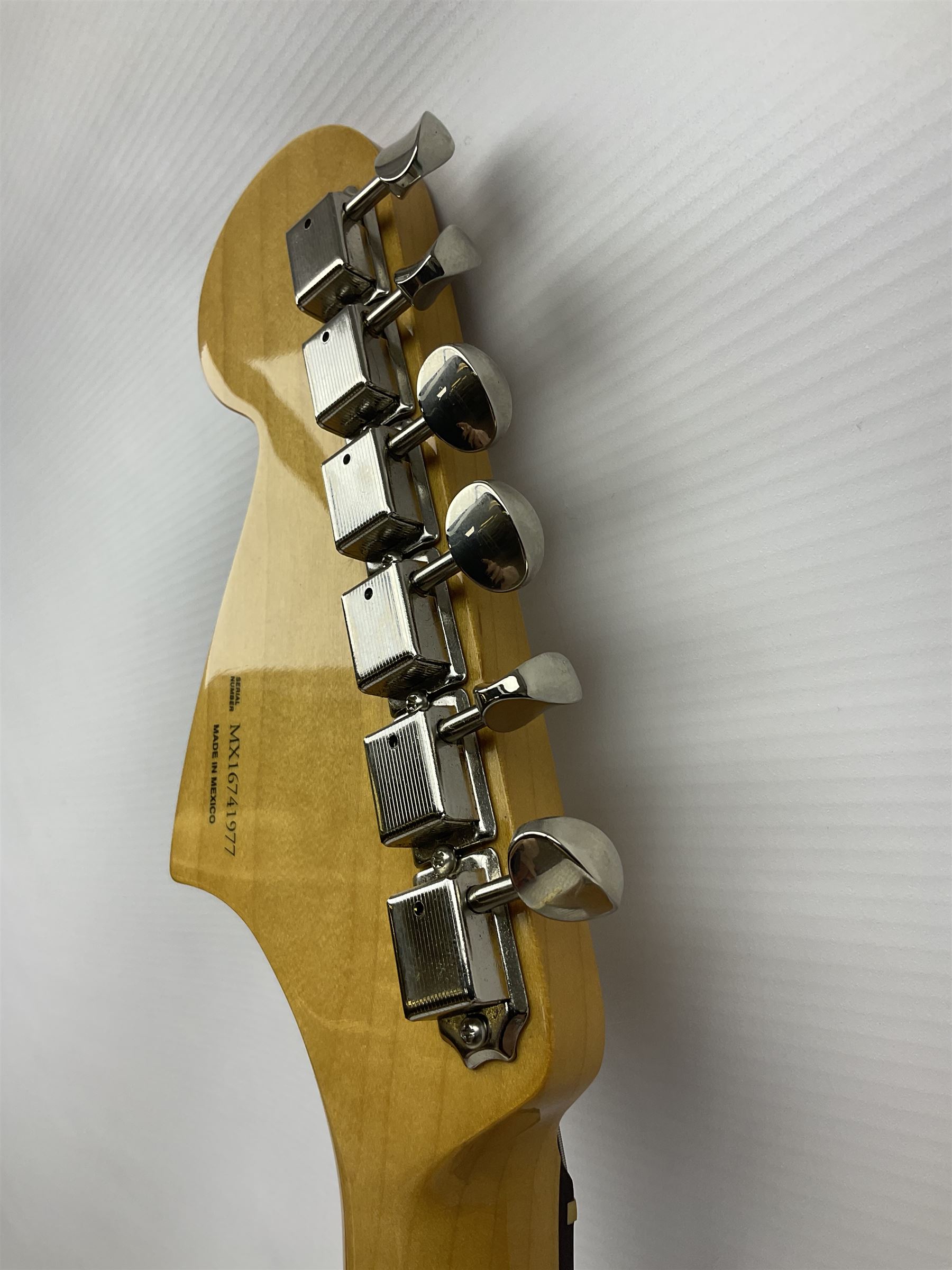 Mexican Fender Jaguar electric guitar with Humbucker pick-ups and tremolo arm, serial no.MX16741977, L101cm; in soft carrying case