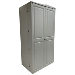 Large white finish sewing cabinet, enclosed by two doors fitted with thread holders and shelves, the interior fitted with shelves and sliding trays, with fold down work surfaces 