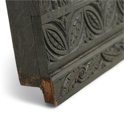 Victorian heavily carved oak wall mirror, lunette and foliage carved frieze over central bevelled mirror and flanking panels carved with floral urns, the upright frame decorated with geometric pattern chip carvings, lunette carved lower rail 