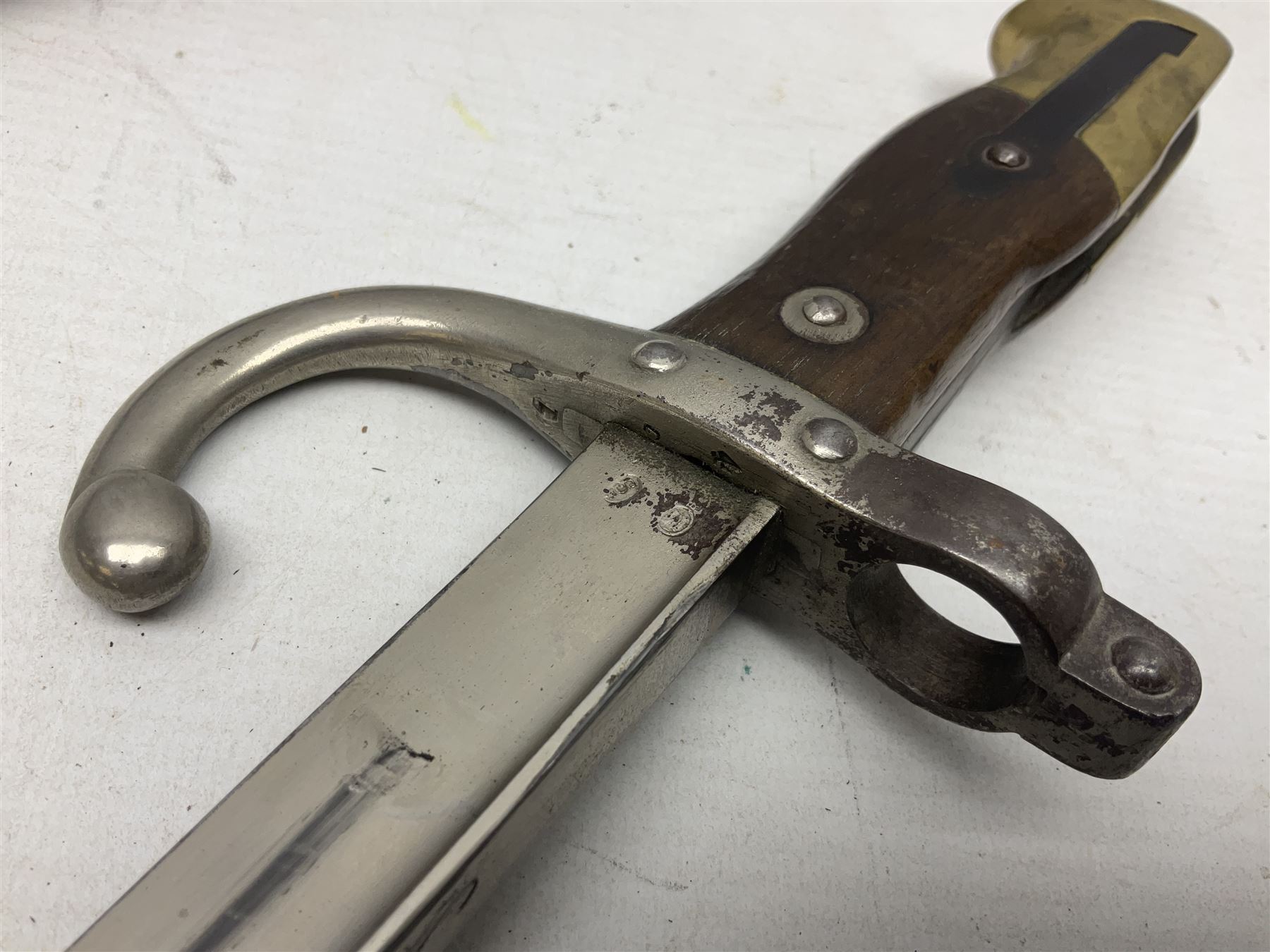 French Model 1866 Chassepot bayonet with 57cm curving fullered steel blade dated 1873 No.L63963; in steel scabbard with conforming number L71.5cm overall; and French St. Etienne Gras bayonet dated 1878 No.K10674 in steel scabbard numbered 79437 (2)