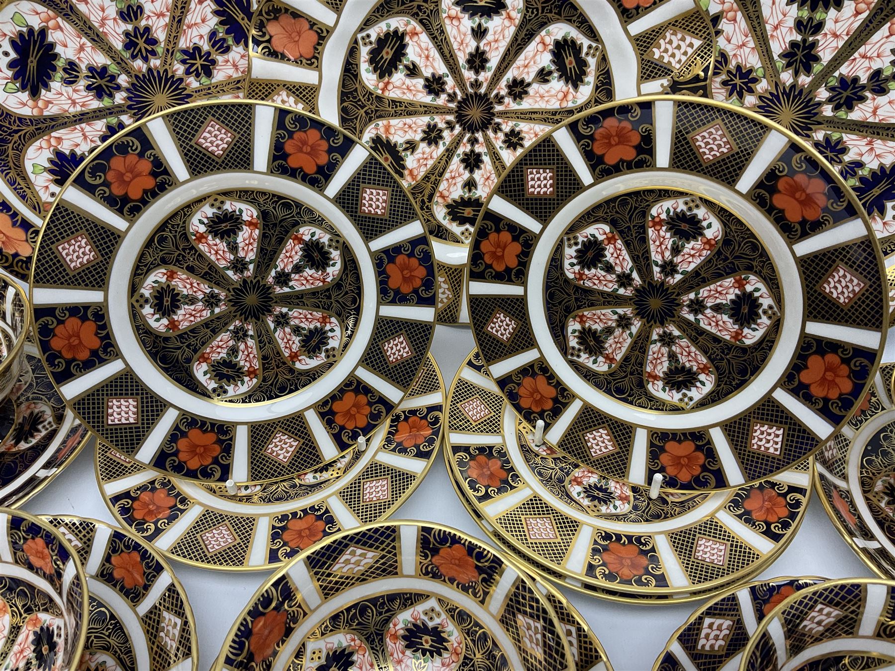 20th century Royal Crown Derby Imari 1128 pattern tea wares, comprising six teacups, five saucers, five side plates, a pair of serving plates, and one other with wavy rim, each with printed marks beneath including various year cyphers, side plates D16cm serving plates each approximately D22cm